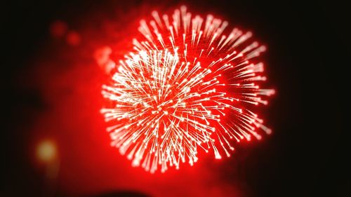 Low angle view of firework display at night