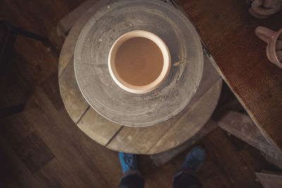 Low section of person standing on wooden table