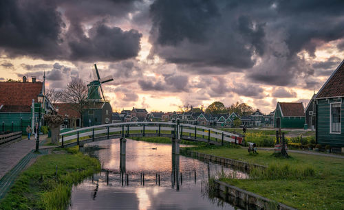 Bridge over canal against sky during sunset