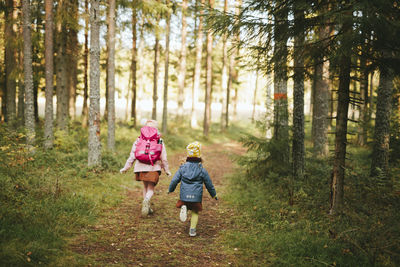 Full length of woman walking in forest