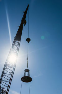 Low angle view of crane against clear sky