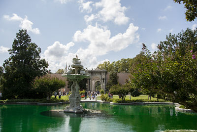 View of fountain in lake against sky