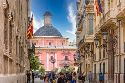 Group of people in front of buildings in city