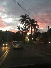 Cars on road at sunset