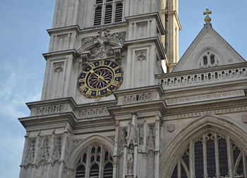 Low angle view of clock tower against sky