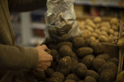 Bag with potatoes. vegetables in kitchen. potatoes in plastic bag. children of market. 