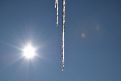 Low angle view of vapor trail against clear blue sky