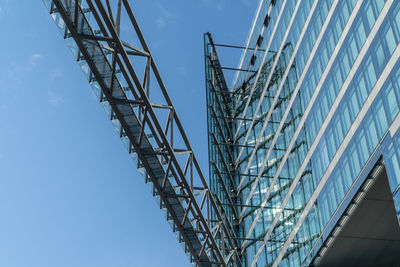 Low angle view of modern building against blue sky