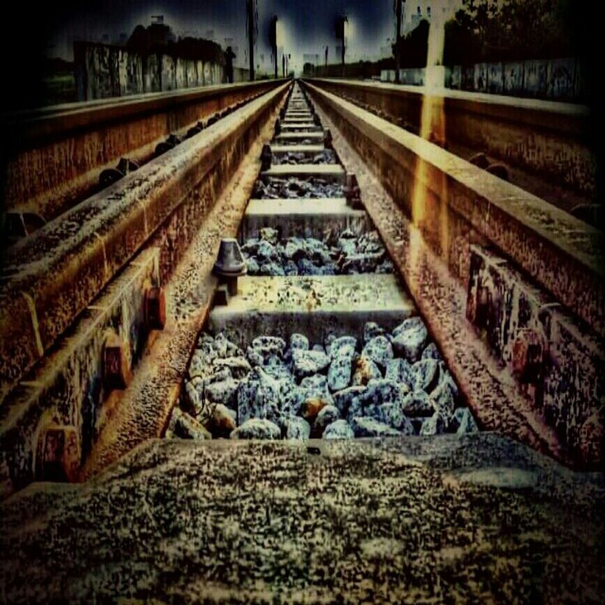 the way forward, diminishing perspective, vanishing point, railroad track, transportation, surface level, built structure, rail transportation, long, connection, architecture, straight, no people, day, outdoors, stone - object, railway track, in a row, bridge - man made structure, wood - material