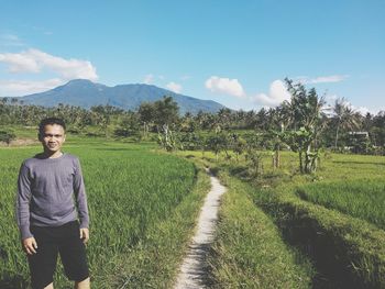 Man standing on field against sky