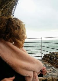 Rear view of woman looking at sea against sky