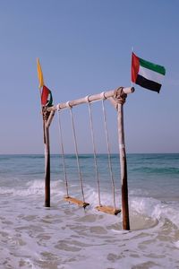 Lifeguard hut on beach against clear sky