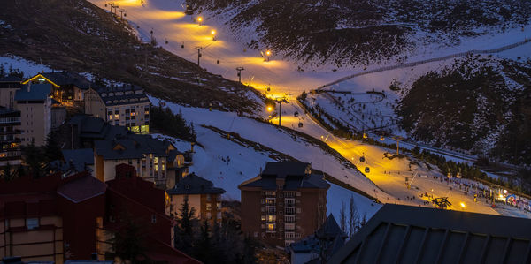 High angle view of illuminated buildings in city at night