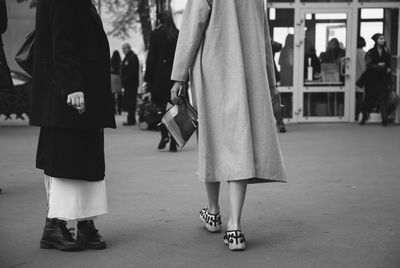 Low section of people standing in city