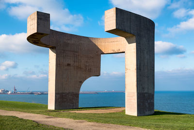 Built structure on beach against sky