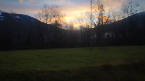 Scenic view of field against sky during sunset