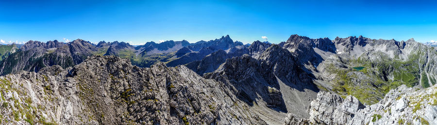 Scenic view of rocky mountains against blue sky