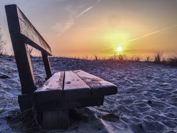 Scenic view of snow covered landscape at sunset
