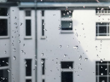 Full frame shot of wet glass window in rainy season