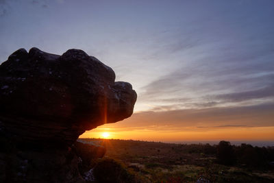 Scenic view of rock formation against sky during sunset