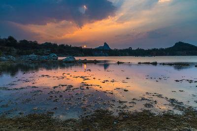 Scenic view of lake at sunset