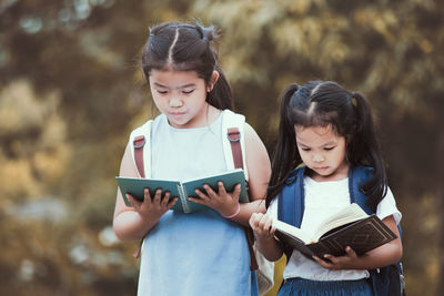 Cute siblings reading books