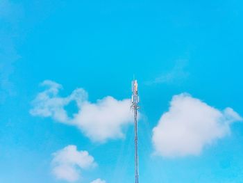 Low angle view of windmill against blue sky