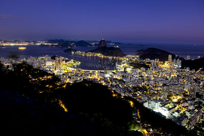 High angle view of city lit up at night