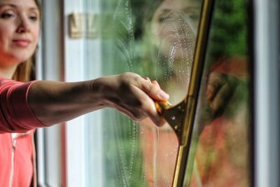 Woman washing glass window