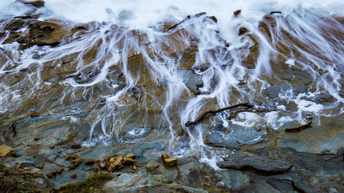 High angle view of icicles on rocks