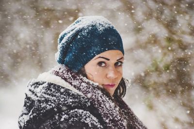 Portrait of young woman in snow