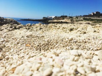 Close-up of sand on beach against clear sky