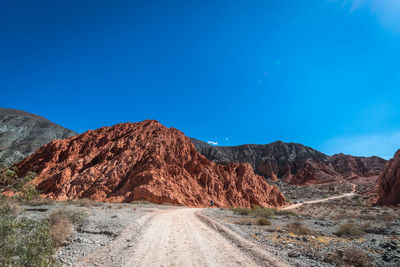 Scenic view of mountain against blue sky