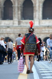 Rear view of people walking on street