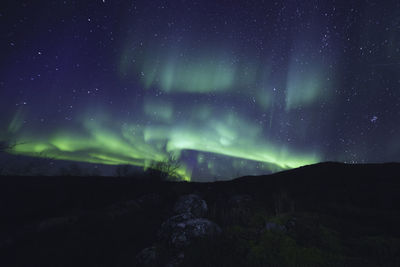 Scenic view of mountain against sky at night