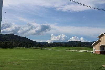 Scenic view of golf course against sky