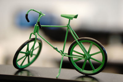 Close-up of bicycle toy against wall