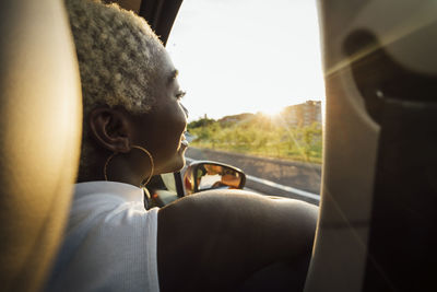 Portrait of man seen through car window