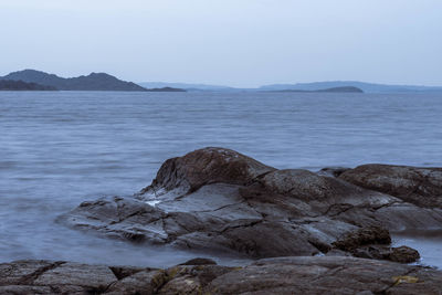 Scenic view of sea and rocks against sky