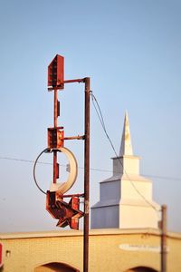 Derelict sign and church steeple in morning light