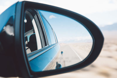 Close-up of side-view mirror of car