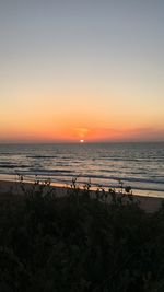 Scenic view of sea against clear sky during sunset