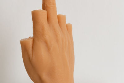 Close-up of hand against white background