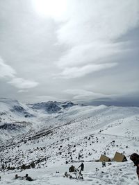 Scenic view of snow covered mountains against sky