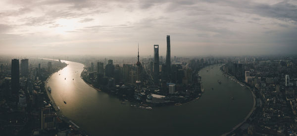 High angle view of buildings against cloudy sky