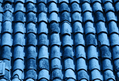 Blue colored old tile roof background, trendy color background.