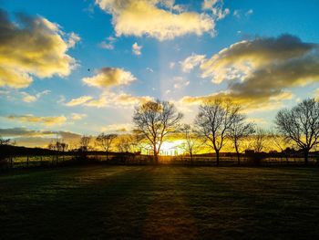 Scenic view of field against sky during sunset