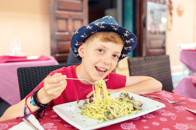 Portrait of boy sitting on table