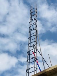 Low angle view of electricity pylon against sky