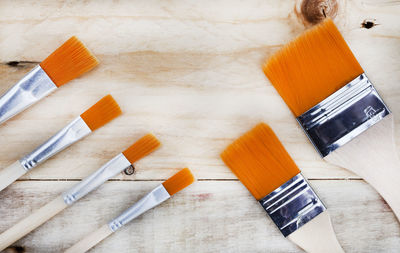 Rustic surface with new and clean, soft bristled paintbrushes and ample copy space